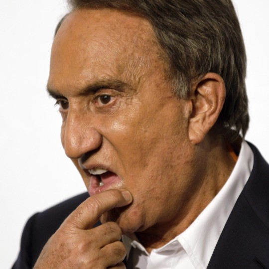 In this photo taken on Sept. 27, 2010, Italian journalist Emilio Fede touches his chin, in Milan, Italy. A Milan court, Friday, July 19, 2013 has convicted three of ex-premier Silvio Berlusconi's former aides of procuring prostitutes for the media mogul's infamous "bunga bunga" parties. The court Friday handed out stiff sentences to Emilio Fede, a longtime executive in the mogul's TV networks; Dario Mora, a talent agent, and Nicole Minetti, a former regional politician who professed love for the ex-premier. Berlusconi wasn't on trial in this case, but was convicted separately last month of paying for sex with a minor and trying to cover it up. Prostitution among adults is legal but exploiting prostitutes is a crime. (AP Photo/Luca Bruno)