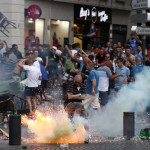 MARSEILLE, FRANCE - JUNE 10: A tear gas canister explodes under a football fan as England fans clash with police in Marseille on June 10, 2016 in Marseille, France. Football fans from around Europe have descended on France for the UEFA Euro 2016 football tournament.  (Photo by Carl Court/Getty Images)
