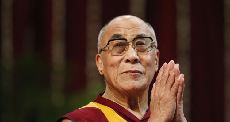 The Dalai Lama gestures before speaking to students during a talk at Mumbai University February 18, 2011. REUTERS/Danish Siddiqui (INDIA - Tags: EDUCATION RELIGION) - RTR2IRAI